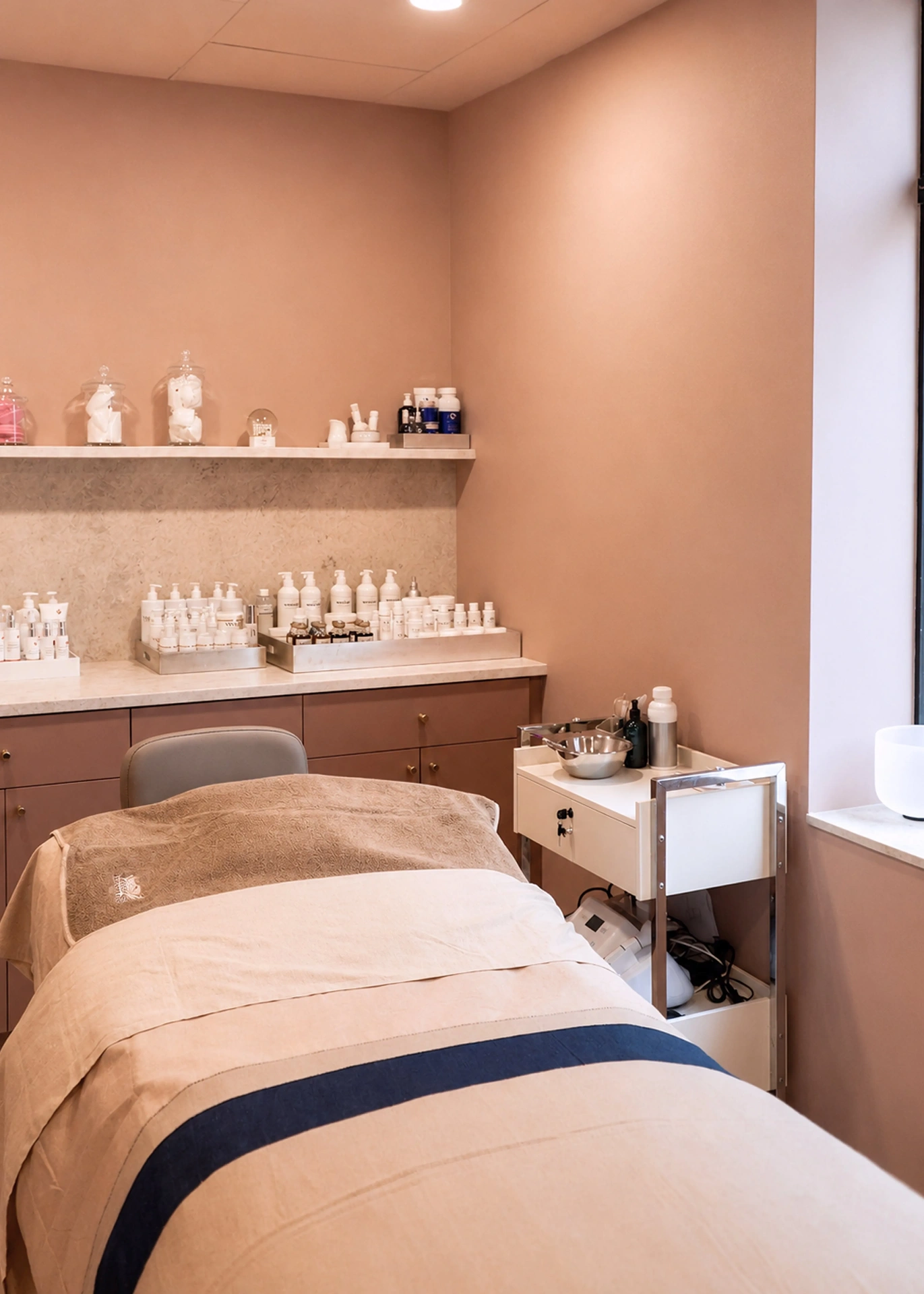 Serene treatment room with warm terracotta walls