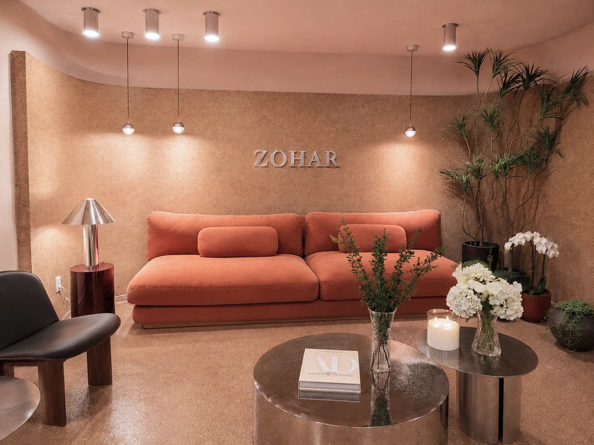 Zohar reception lounge with terracotta sofa and cork-textured walls
