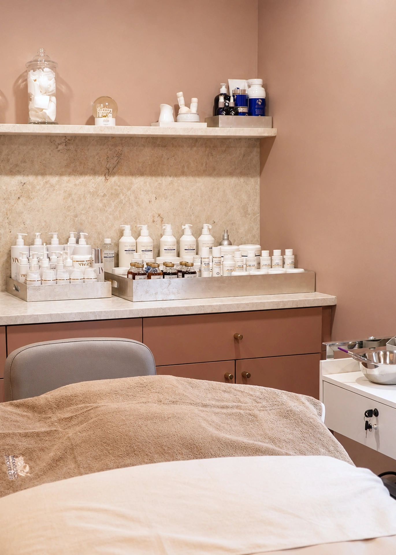 Facial treatment room with marble shelf and skincare trays